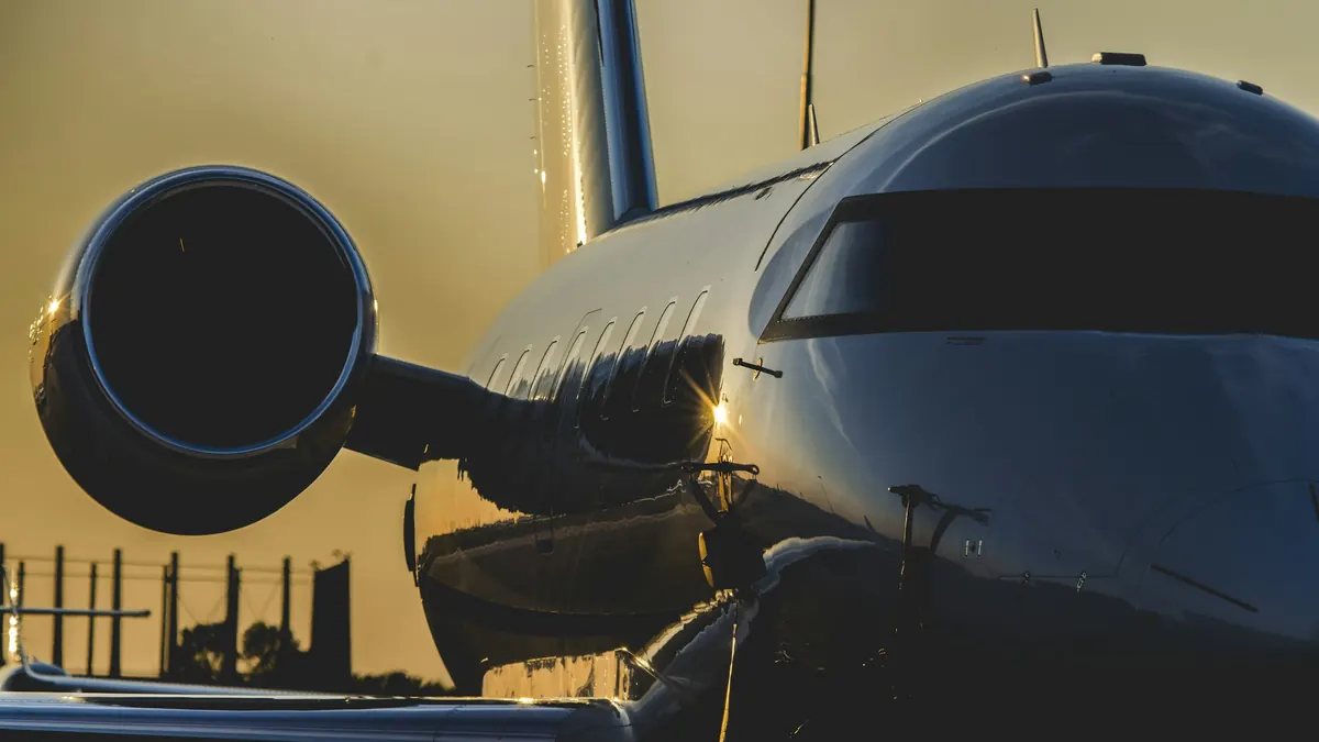 Engine nacelle and polished fuselage of a business jet in golden evening light